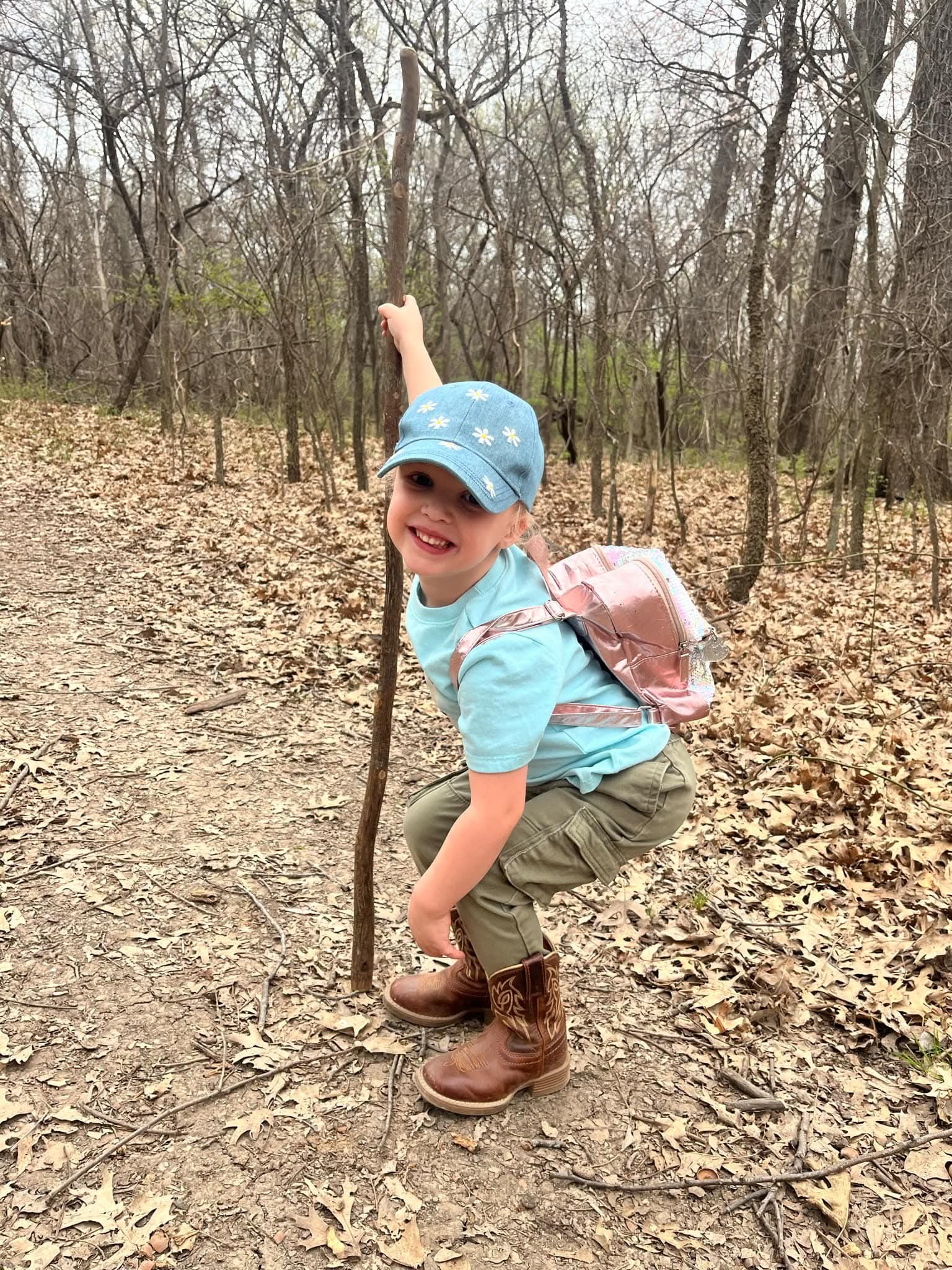 Girl exploring with a walking stick