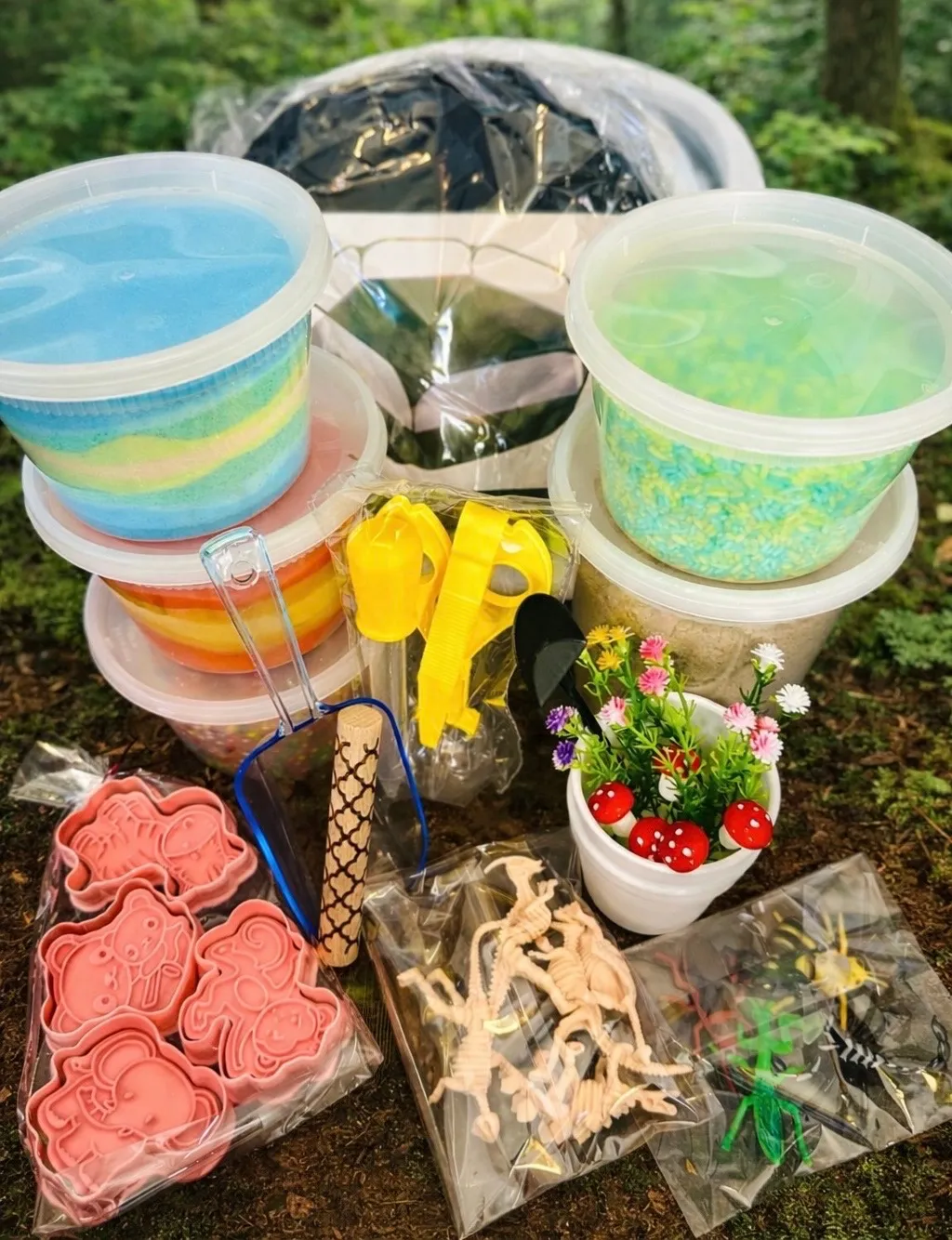 Nature play sensory kit with sensory tubs, toy bugs, animal stamps, scoops, flowers, and activity materials